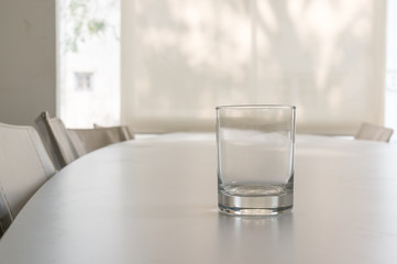 Closeup of a glass on the table in meeting room