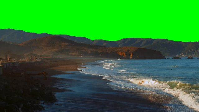 Coastal Waters - Green Screen Chroma key / Coastal waves break as people frolic in the water. Background is pre-keyed in green.