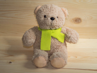 lovely bear doll and  citrine scarf,wooden background