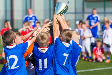 Young Sport Players Holding Trophy. Boys Celebrating Soccer Championship