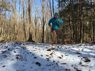 Man running on snow covered winter trail