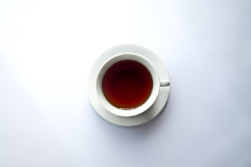 White tea cup with red tea on white background
