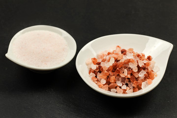 Fototapeta na wymiar pink himalayan salt over slate background