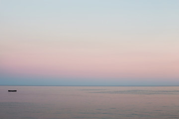 Peaceful morning at the sea. Soft pink colors of the sunrise