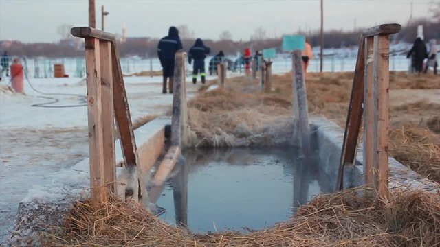 The  man bathes in an ice-hole on the Epiphany in Russia