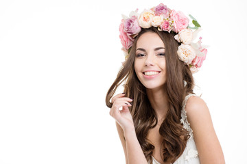 Happy woman with wreath of roses looking at camera