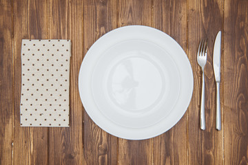 Knife, fork, napkin and dinner plate