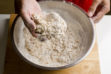 Mixing flour and yeast in the bowl by hand,bread cooking