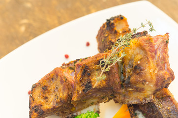 Delicious rib steak and vegetables placed on white plate, elegant presentation