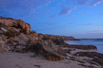 Spectacular eroded coastal cliff bay at sunset