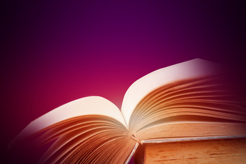 Abstract purple magic book on wooden background