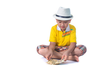 Asian child holding money while standing isolated on white backg