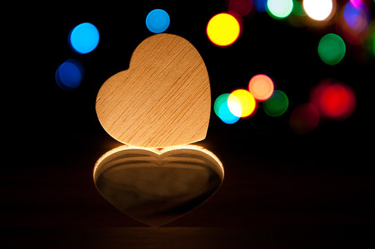 Wooden heart in dark light , holiday abstract background