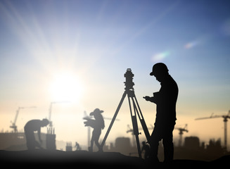 silhouette black man survey and civil engineer stand on ground w - obrazy, fototapety, plakaty