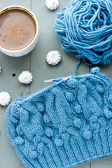 Obraz na płótnie Canvas Knitting a turquoise pattern on the circular needles