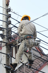 Electricians working on the electricity pole.