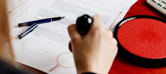 Notary public stamping document.