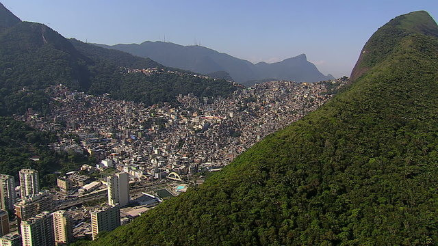 Flying over trees and mountains with Favela, Rio de Janeiro, Brazil