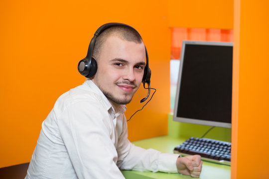 businessman with a headset portrait at bright call center helpde