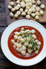 Close-up of potato gnocchi with tomato sauce and parsley