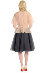 woman in a blouse and skirt back isolated on white