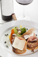 Roasted beef fillet on plate with wine glass and bottle