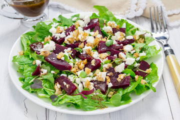 Salad with beets, feta cheese and walnuts, dressed with balsamic sauce