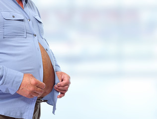 Big fat belly over blue background.