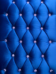 Blue upholstery velveteen decorated with crystals as texture and