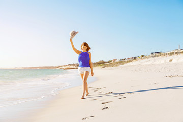 Young woman walking along the beach