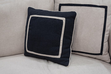 navy blue pillow on grey sofa