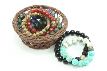 beautiful accessory stone bracelet in basket isolated background