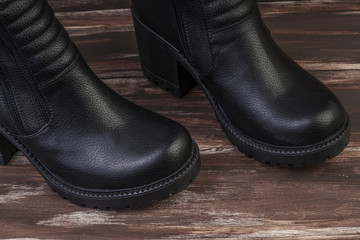 pair of leather boots on wooden surface