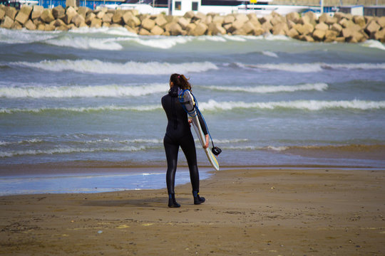 SURFER GIRL ON A BEACH