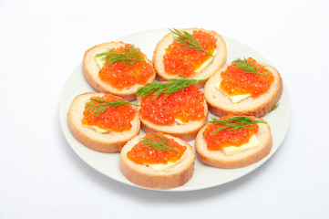 Bread with butter and red caviar in white plate. Sandwiches with