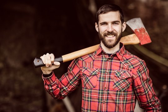 Portrait of smiling man with axe