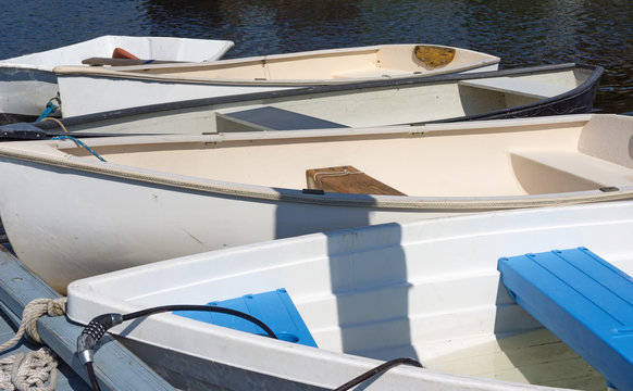 Group of dinghies tied to dock
