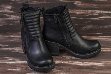 pair of leather boots on wooden surface