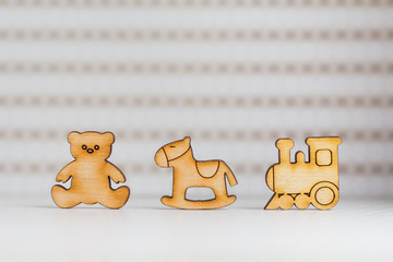 Wooden icon of Teddy bear, children's rocking horse and locomoti