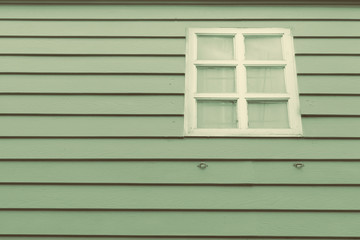 Window with green wood background in retro tone
