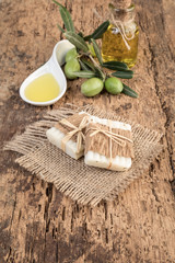 natural olive oil, olives and soap bars on wood