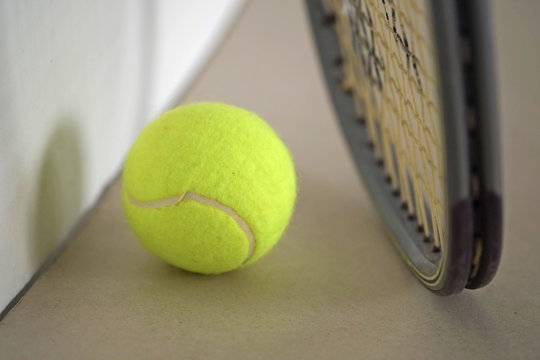 Tennis ball with racket / Tennis ball with racket on the ground.