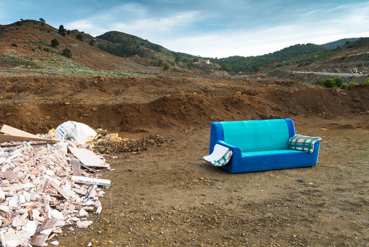 Old sofa in a landfill. Region of Murcia. Spain