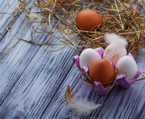 Brown and white eggs on  wooden background