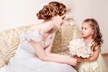 Beautiful vintage bride and flower girl  with peony bouquet. Wedding. Just married