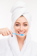 Close up photo of  cute girl with towel on her head holding toot