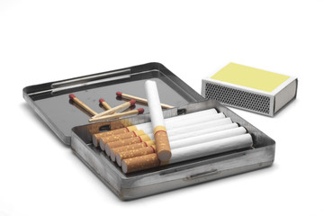 Cigarettes / Cigarettes in a box with matchstick.