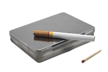 Cigarettes / Cigarette on a box with matchstick.