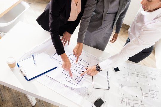 Business people discussing layouts