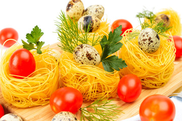 Pasta nests with cherry tomatoes and quail eggs.
